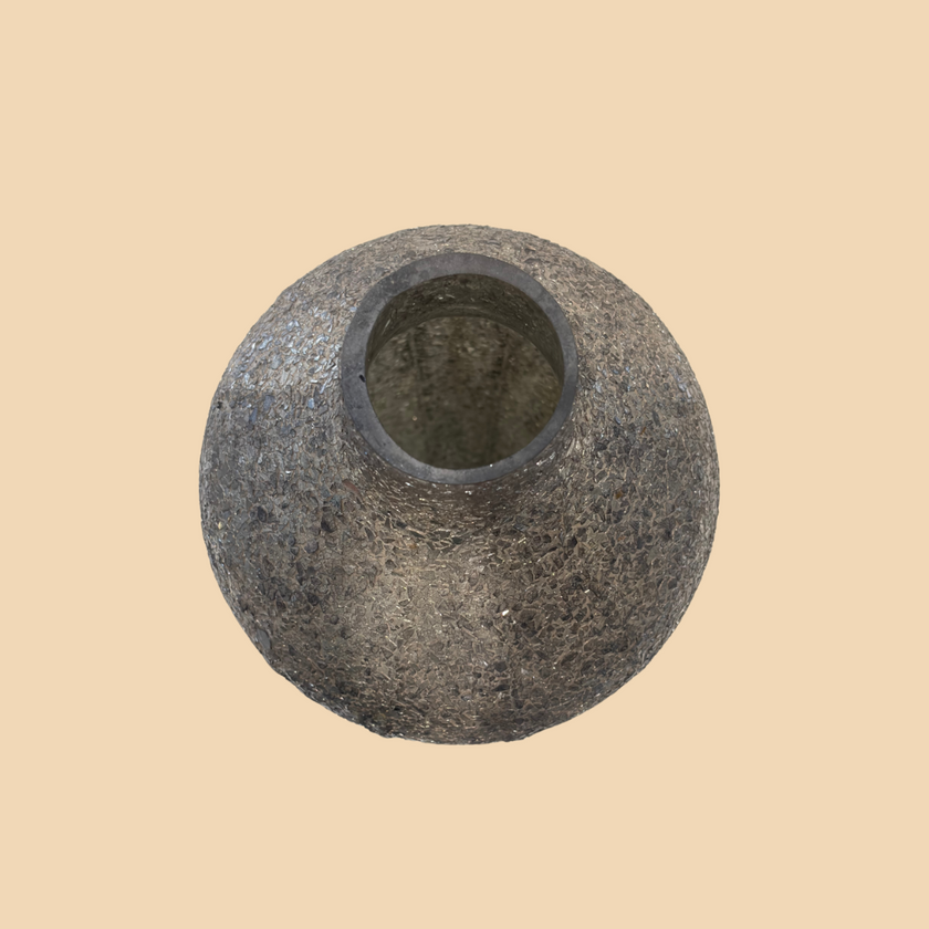 Round stone object on a beige background