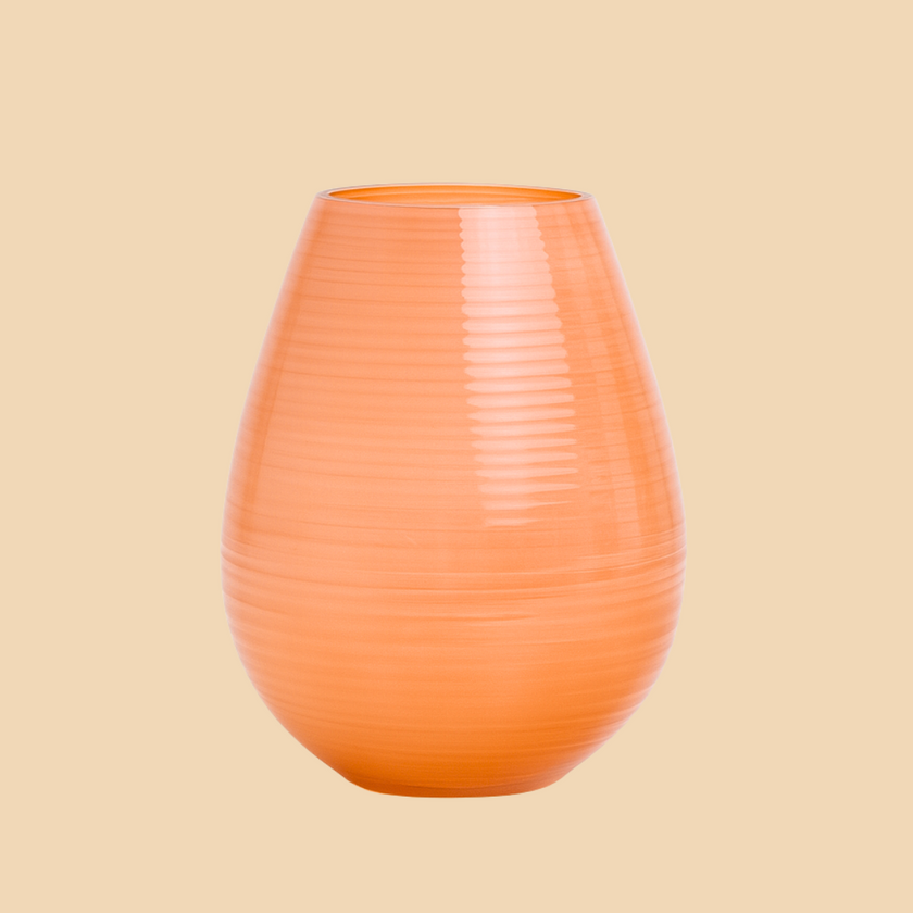Orange ribbed vase on a beige background