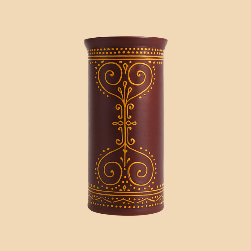 Decorative cylindrical container with gold patterns on a beige background