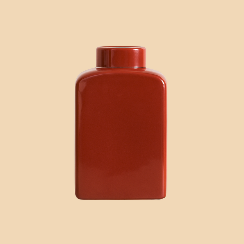 Red rectangular jar on a beige background