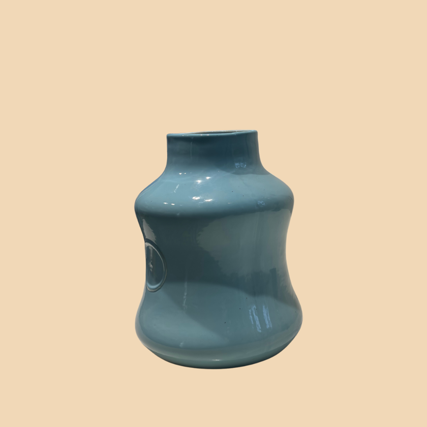 Blue ceramic vase on a beige background
